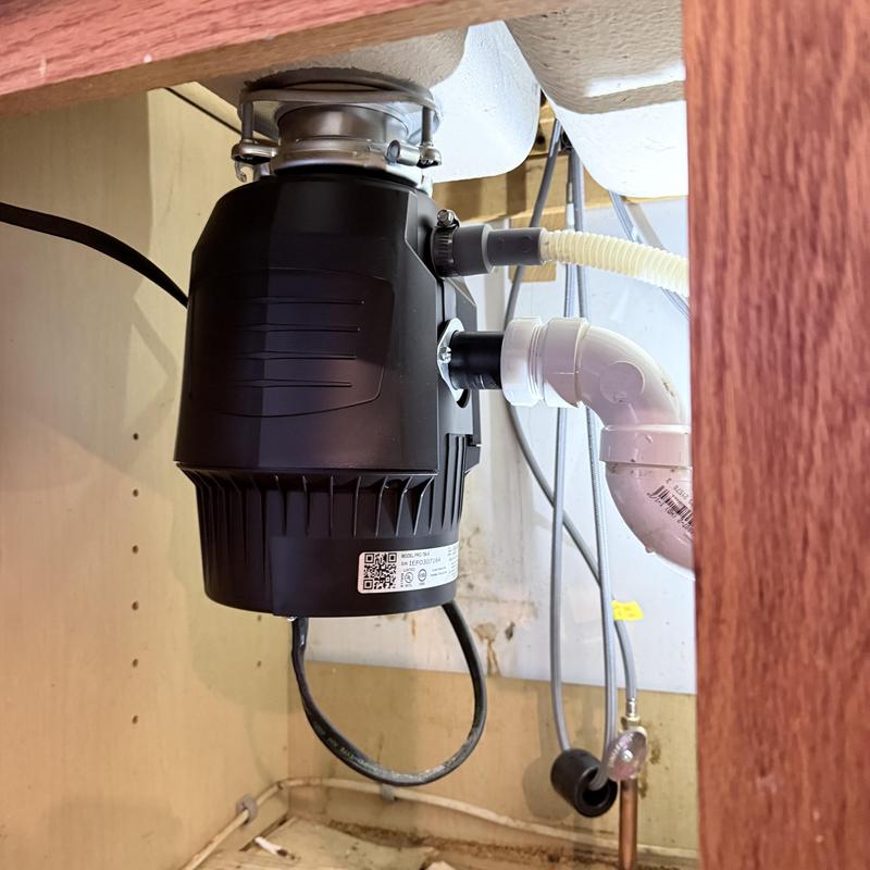 Garbage disposal unit installed under kitchen sink