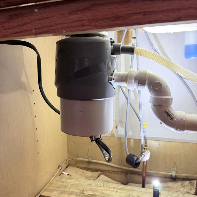 Garbage disposal unit installed under kitchen sink