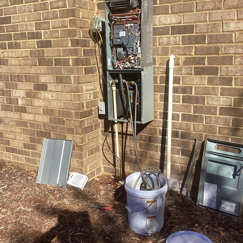 HVAC condenser unit with open panel and maintenance tools HVAC condenser unit with open panel and maintenance tools