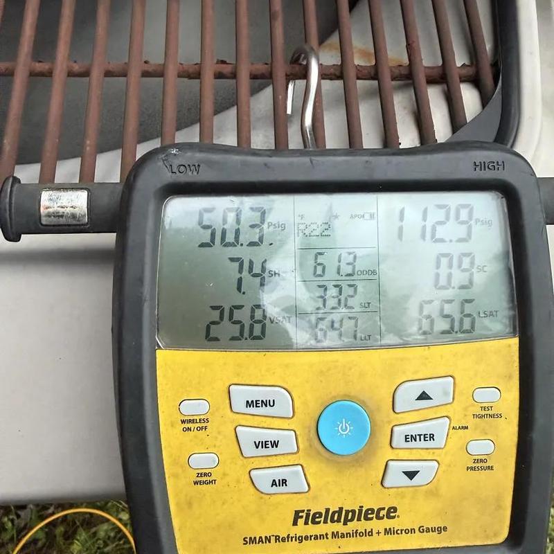 Refrigerant manifold gauge showing system pressure readings Refrigerant manifold gauge showing system pressure readings
