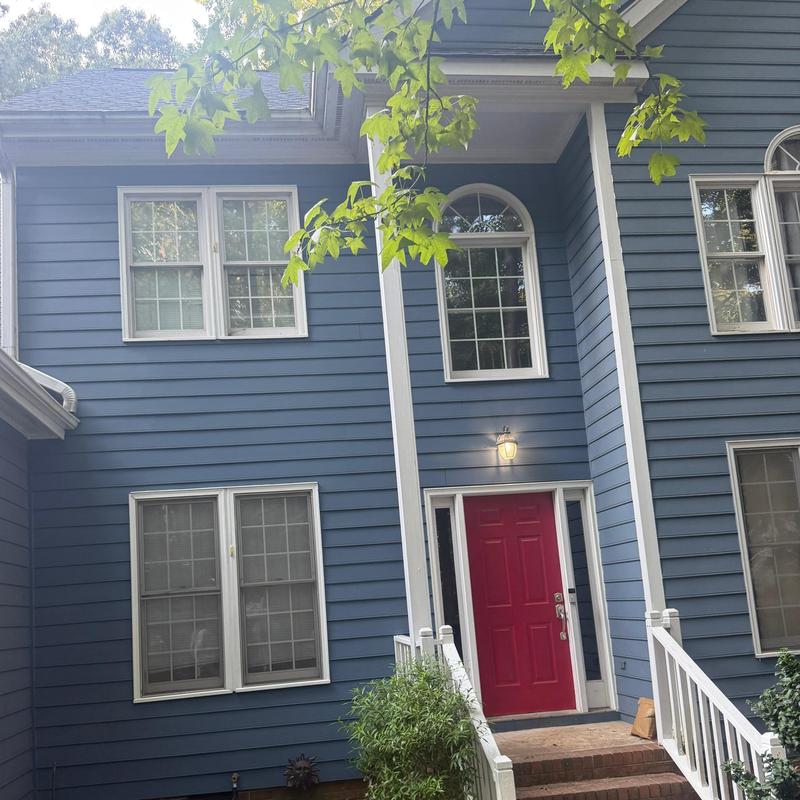 Blue siding and red front door on two-story house