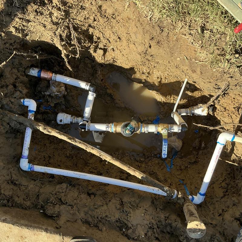 Main water line with ball valve, pressure reducer, and tank