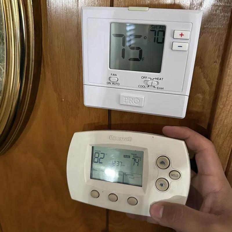 Thermostat replacement with new digital model on wood wall Thermostat replacement with new digital model on wood wall