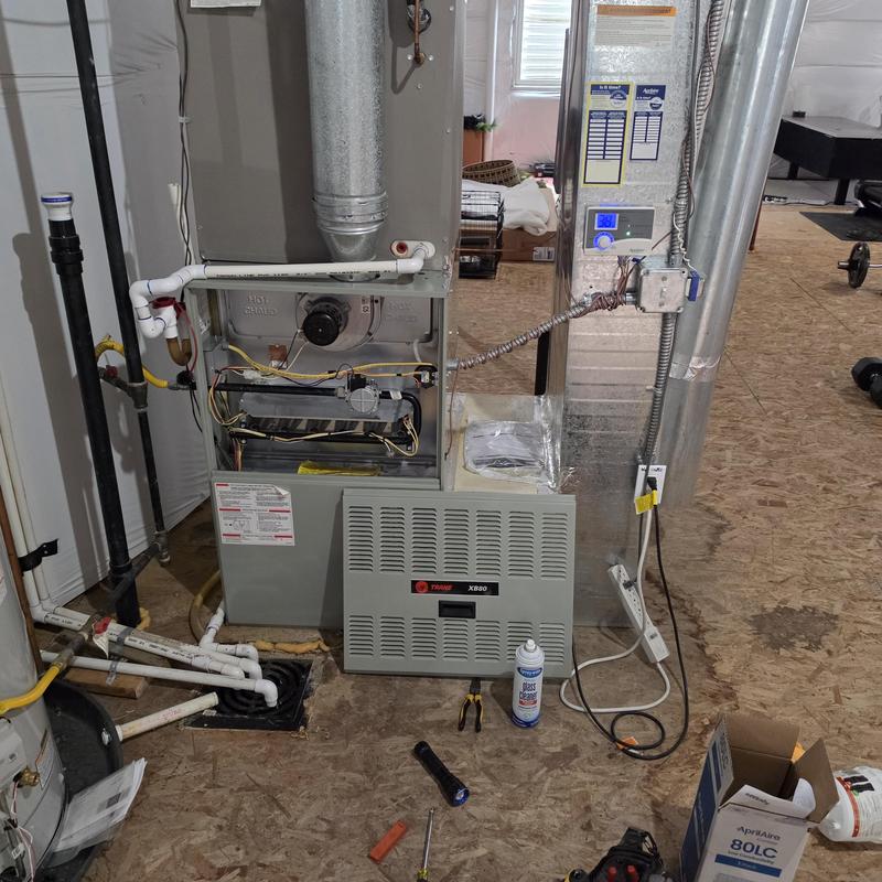 Trane furnace with front panel removed and tools nearby Trane furnace with front panel removed and tools nearby