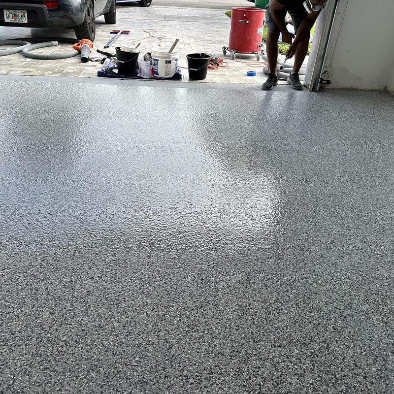 Gravel flake epoxy garage floor coating in progress