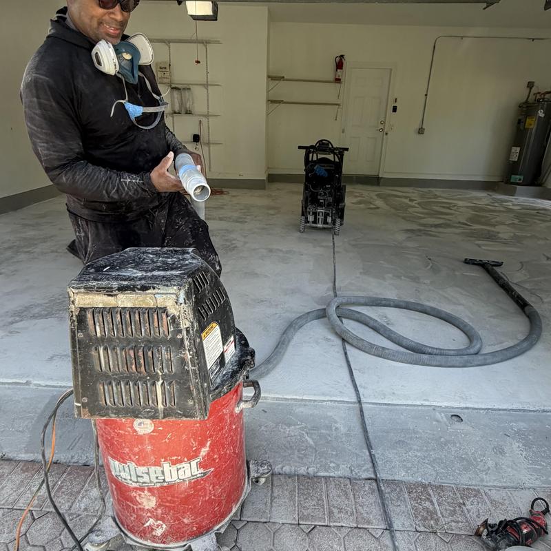 Concrete grinding machine prepping garage floor in Miami