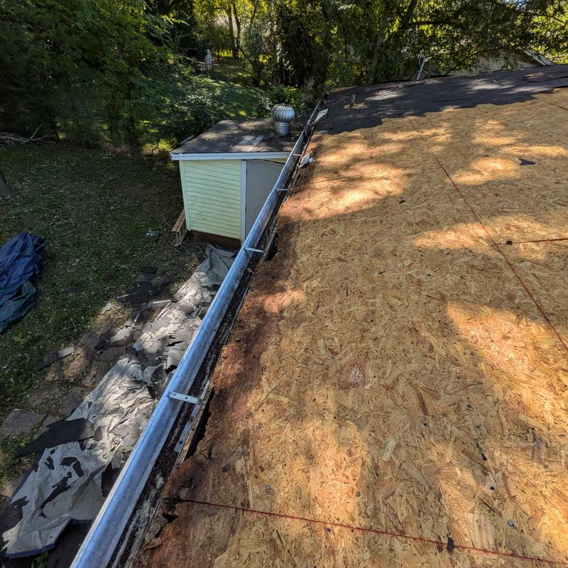 Roof decking replacement with gutter removal and debris