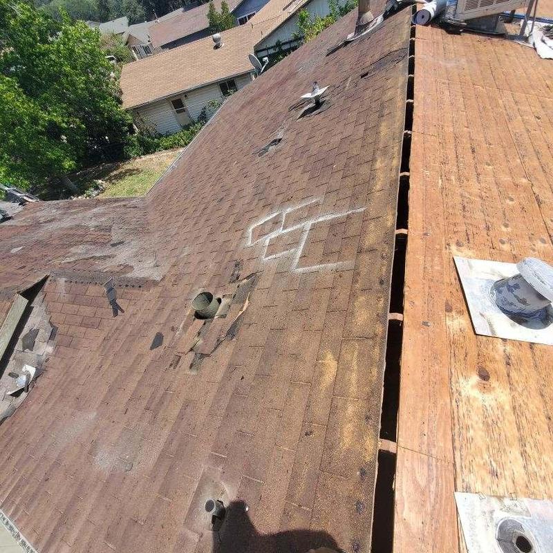 Asphalt shingle roof with partial plywood decking removal