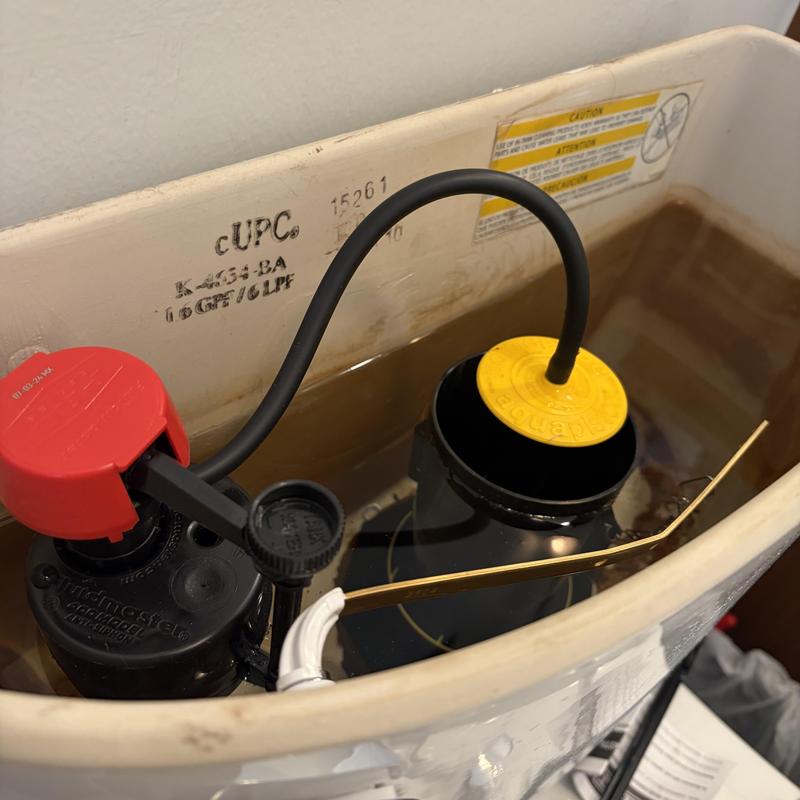 Toilet tank fill valve and float assembly inside tank