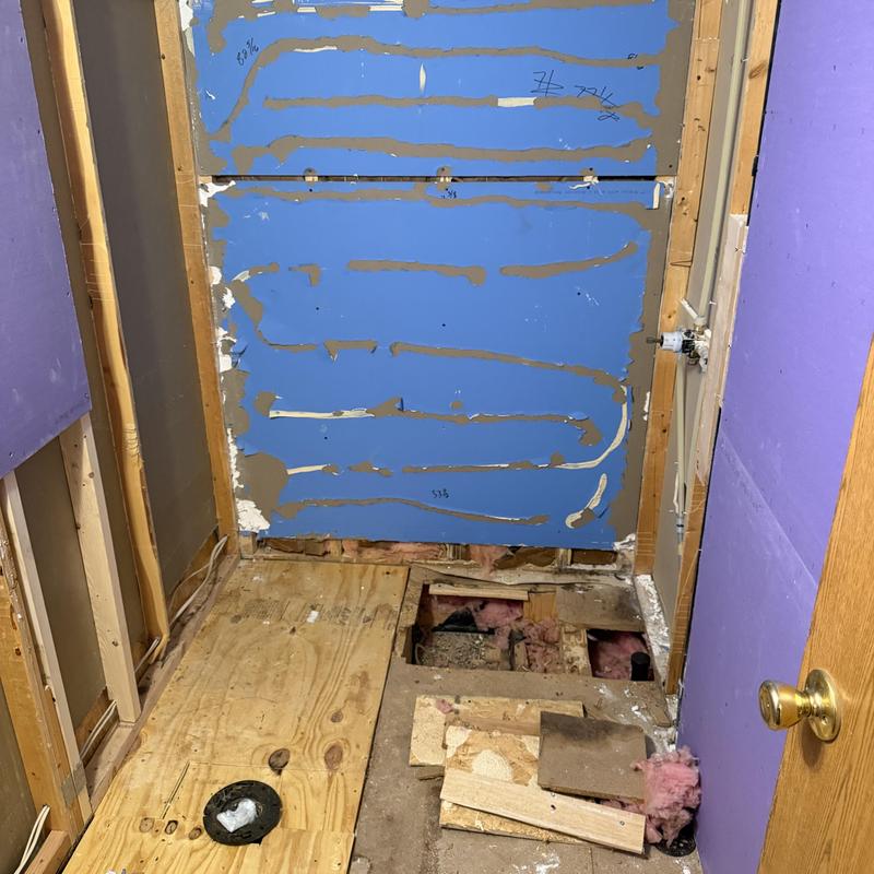 Tub shower surround framing with drain and insulation removed Tub shower surround framing with drain and insulation removed