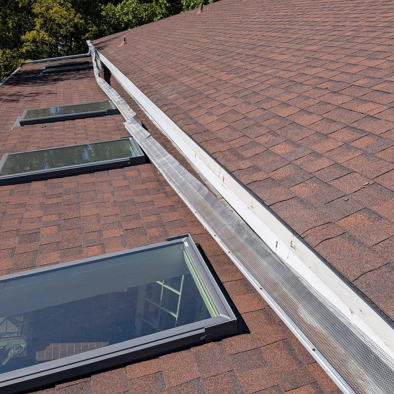 Gutter guard installation on shingle roof with skylights