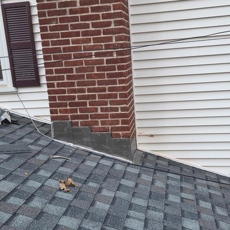 Roof chimney flashing installation on asphalt shingles Roof chimney flashing installation on asphalt shingles