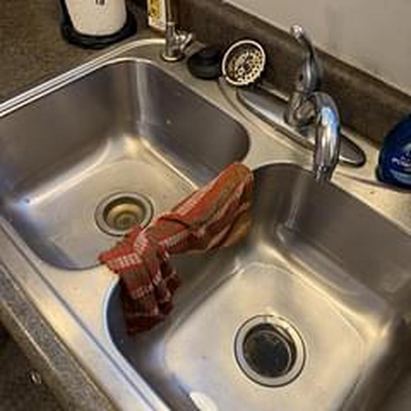 Kitchen sink drain with cleaning cloth nearby