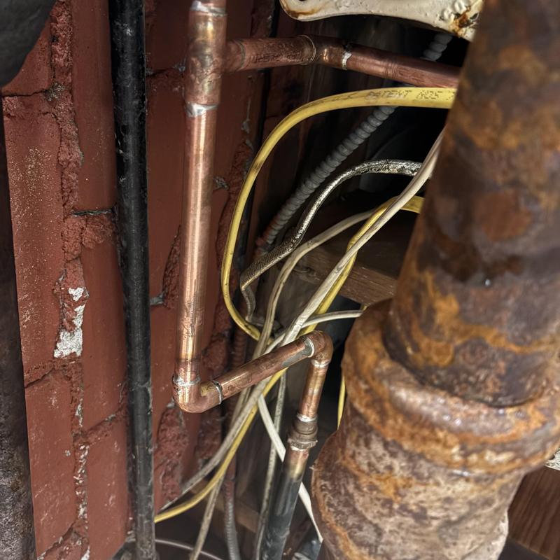 Copper pipe rerouted around structural beam with wiring