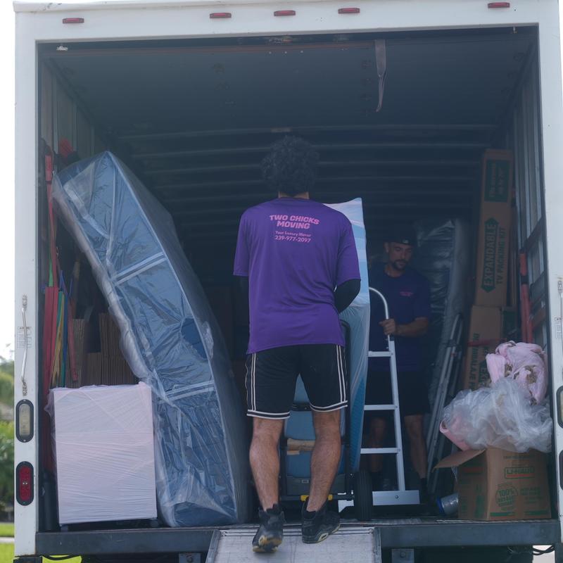 Mattresses and furniture being loaded into moving truck