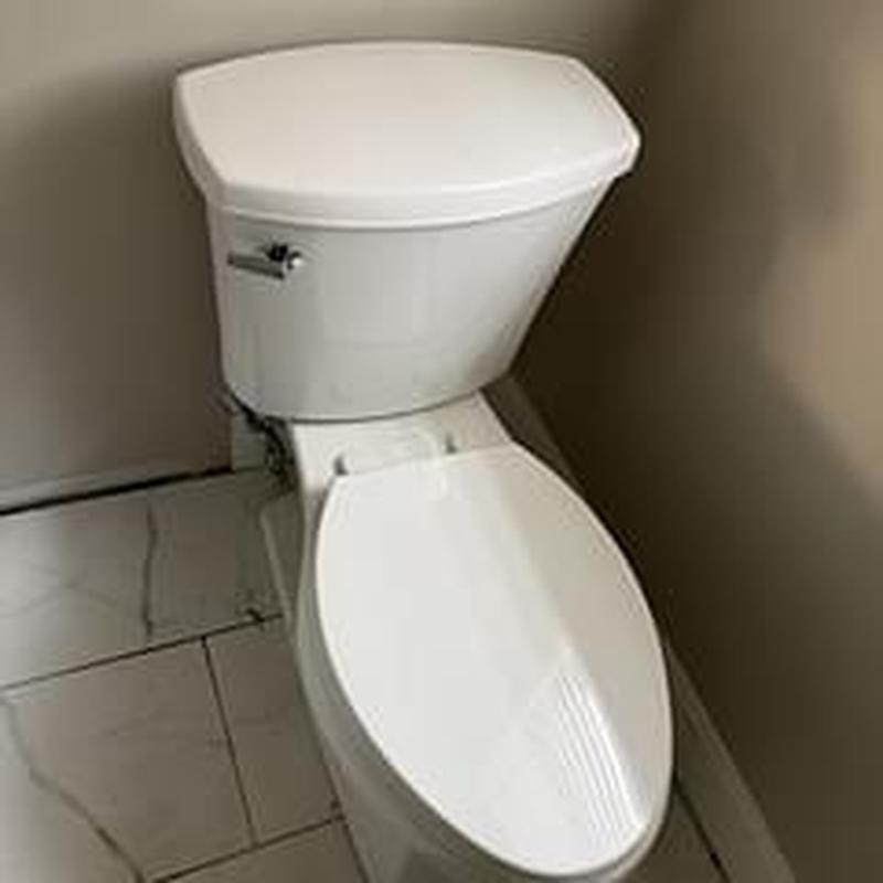 Toilet with new wax ring on tiled floor