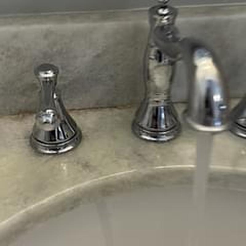 Bathroom sink hot and cold handles with running faucet