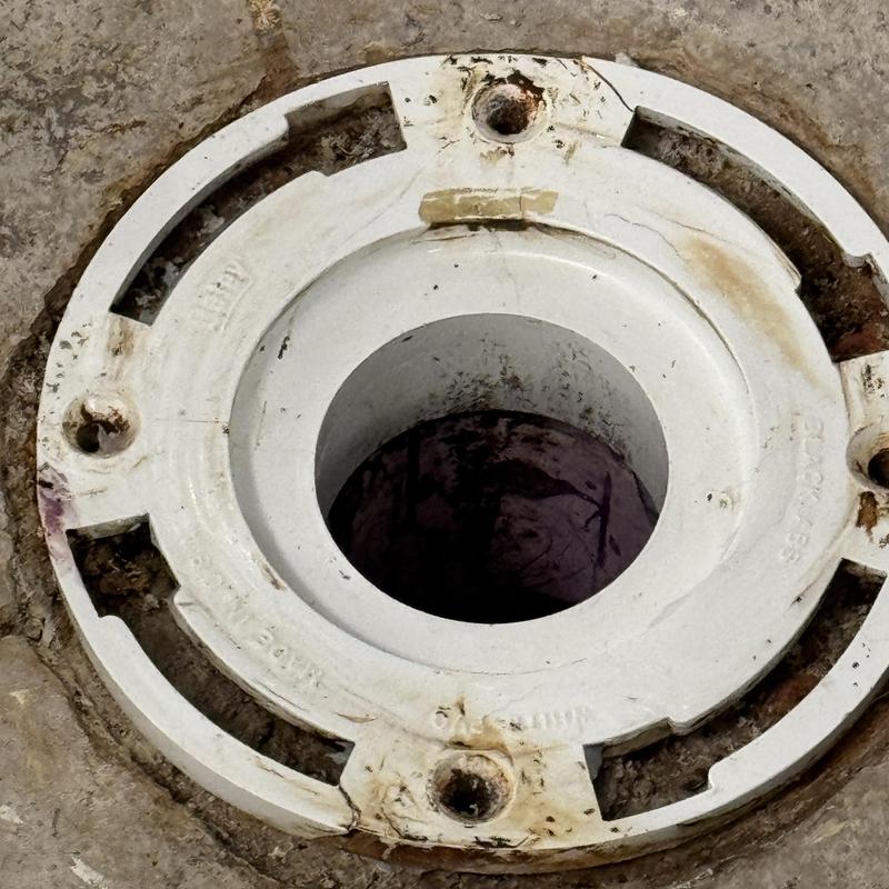 Toilet flange with cracks and bolt holes Toilet flange with cracks and bolt holes