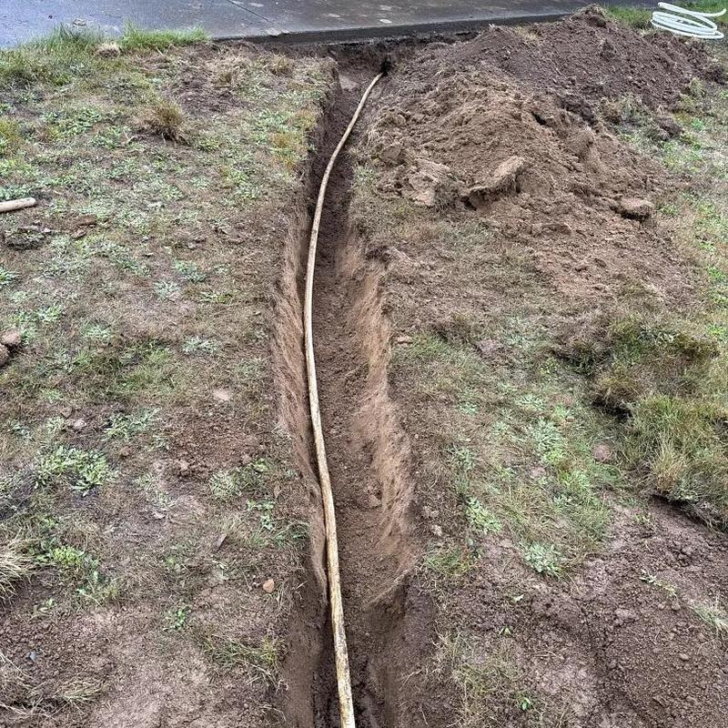 Water line trench with PEX pipe sleeve installation