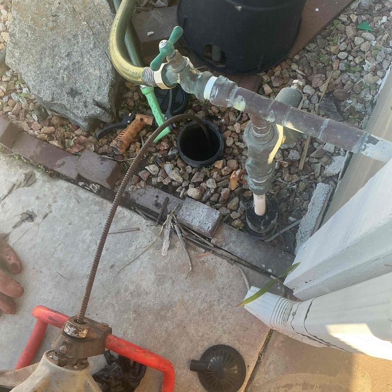 Sewer line snaking at outdoor Pomona Tee junction
