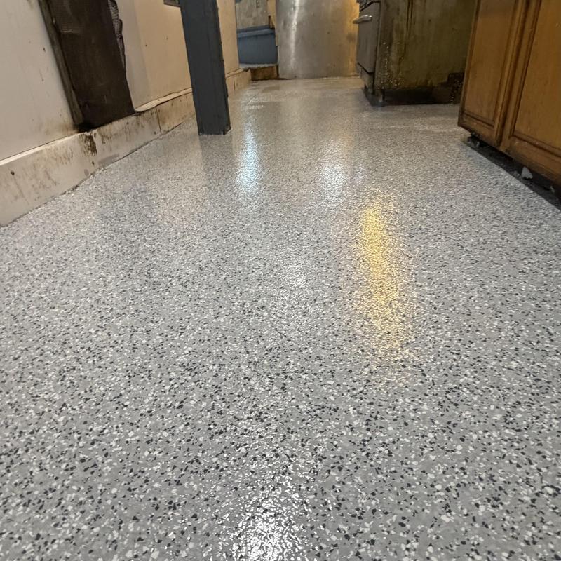 Epoxy flake coated tile floor with polyaspartic topcoat