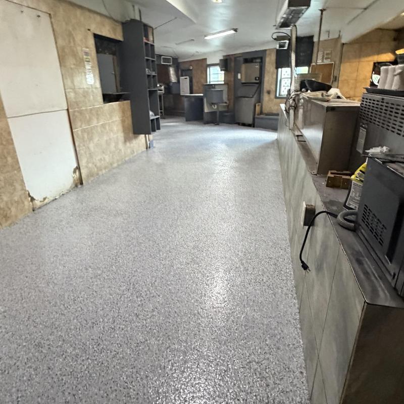 Epoxy flake broadcast flooring with polyaspartic top-coat