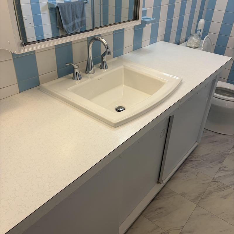 Sink and chrome faucet on bathroom vanity countertop