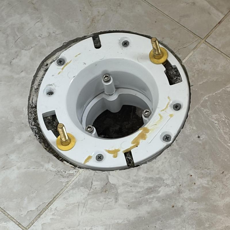 Toilet flange installation on tiled floor